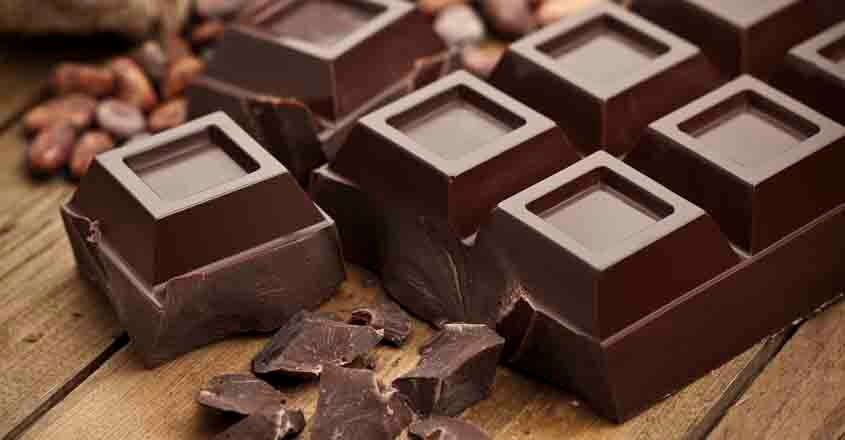 463813283 Dark Chocolate with Chunks on Wood Table